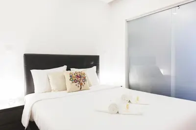 a bedroom with a large white bed with a mirror at APOSENTUS - Your Home in Martires da Liberdade in Porto
