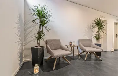 two chairs and a table with two potted plants at 296 Heritage Apartments in Vila Nova de Gaia