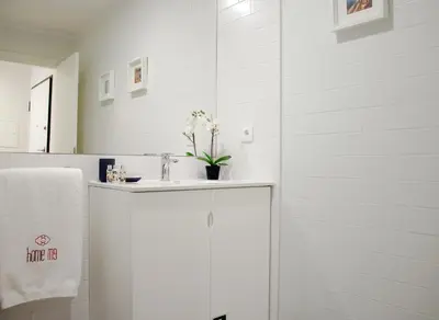 a white bathroom with a sink and a mirror at HM - Carlos Alberto Apartment 3 in Porto