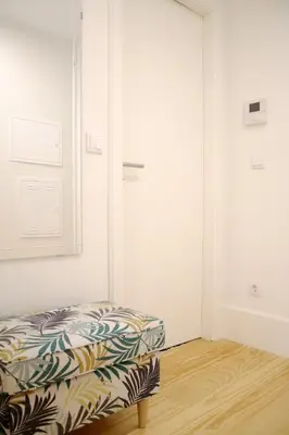 a room with a ottoman sitting on a wooden floor at HM - Carlos Alberto Apartment 3 in Porto