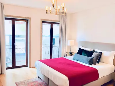 a bedroom with a large bed with a red blanket at Oporto Chic&Cozy - S. Bento in Porto