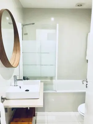 a bathroom with a sink and a tub and a mirror at Oporto Chic&Cozy - S. Bento in Porto