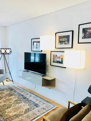 a living room with a flat screen tv on a wall at Oporto Chic&Cozy - S. Bento in Porto