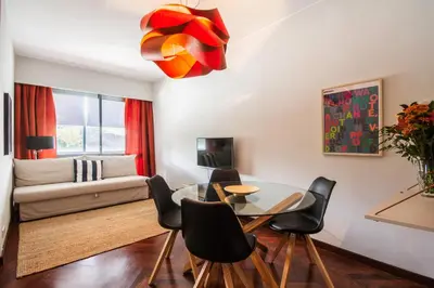 a living room with a table and chairs and a couch at Cozy Stay - Cedofeita 436 in Porto