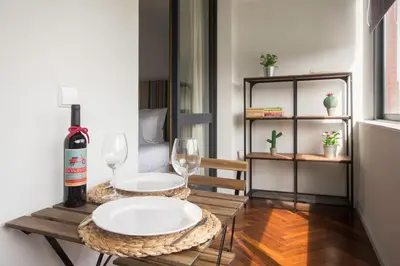a table with two glasses and a bottle of wine at Cozy Stay - Cedofeita 436 in Porto