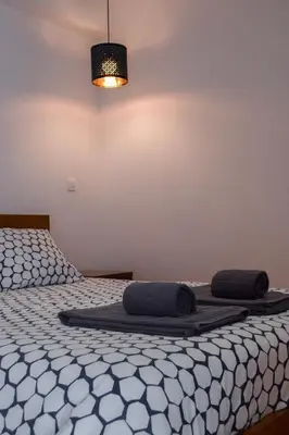 a bedroom with two beds with black and white sheets at Aurora Garden in Porto