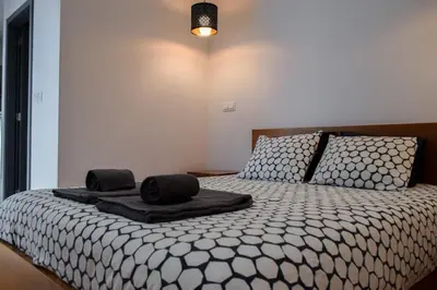 a bedroom with a bed with two towels on it at Aurora Garden in Porto