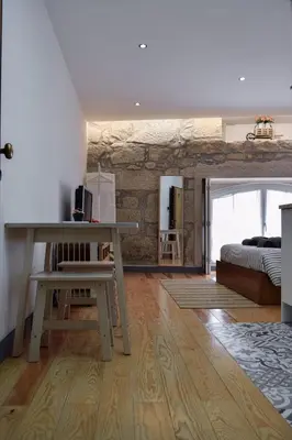 a bedroom with a bed and a desk and a table at Aurora Street in Porto