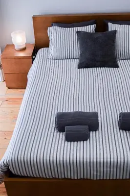 a bed with two pillows on top of it at Aurora Street in Porto