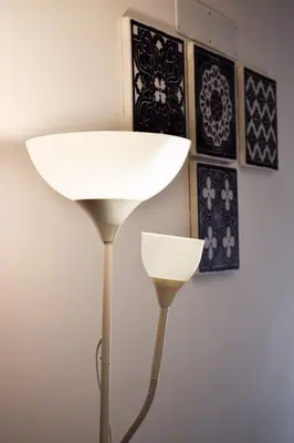 a white lamp next to a wall with pictures at Aurora Sky in Porto