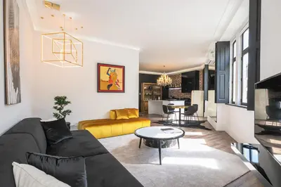 a living room with a couch and a table at ALQUIMIA DOS ALIADOS - Gorgeous Palace Apartment in Porto