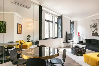 a living room with a couch and a table and chairs at ALQUIMIA DOS ALIADOS - Gorgeous Palace Apartment in Porto