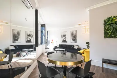 a living room with a couch and a table and chairs at ALQUIMIA DOS ALIADOS - Gorgeous Palace Apartment in Porto