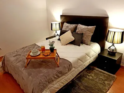 a bedroom with a bed with a coffee table on it at Oporto Cozy Studio in Porto