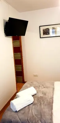 a bedroom with a bed with two white towels on it at Oporto Cozy Studio in Porto