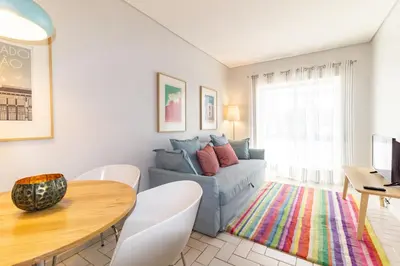a living room with a couch and a table at Cedofeita 408, Green in Porto