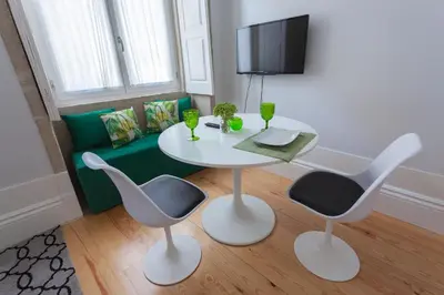 a living room with a table and two chairs and a couch at Oporto City View - Santo Ildefonso Lovely in Porto