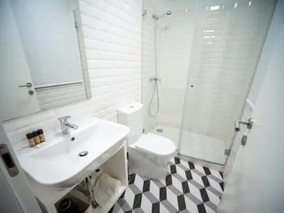 a bathroom with a toilet and a sink and a shower at Oporto City View - Santo Ildefonso Lovely in Porto