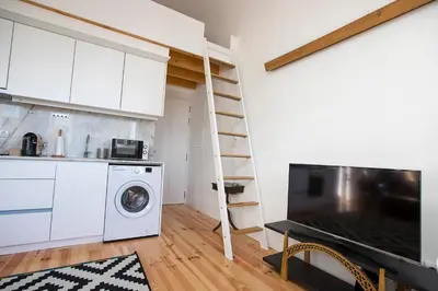 a kitchen with a washer and dryer in a room at Bonfim Apartment in Porto