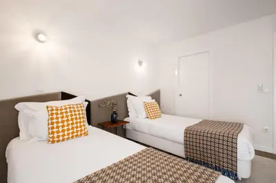 two beds sitting next to each other in a room at Ribeira Apartments Santa Catarina in Porto