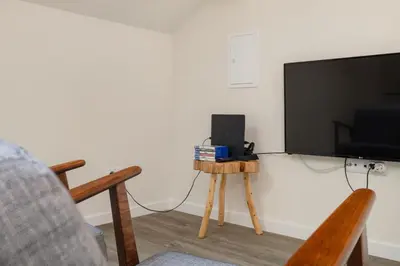 a living room with a flat screen tv and a table at Ribeira Apartments Santa Catarina in Porto