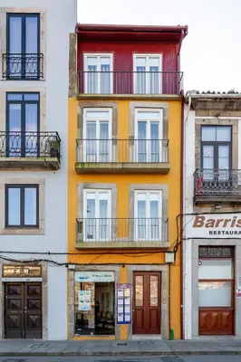 an orange and white building with windows and balconies at YOUROPO - Ribeira Gaia in Vila Nova de Gaia