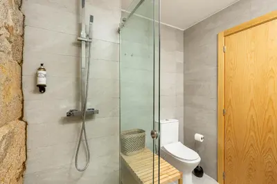 a bathroom with a glass shower with a toilet at YOUROPO - Ribeira Gaia in Vila Nova de Gaia