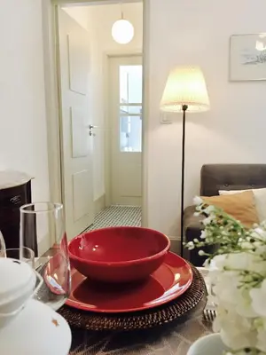 a table with a red bowl on top of it at BS Villas Porto in Porto
