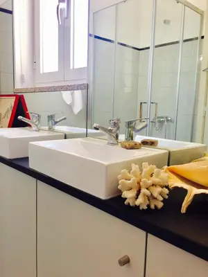 a bathroom with a white sink and a mirror at BS Villas Porto in Porto