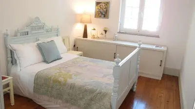 a bedroom with a white bed and a window at BS Villas Porto in Porto