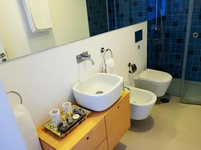 a bathroom with a sink and a toilet at Unique Penthouse Porto near Livaria Lello - 40m2 Terrace and Free Parking in Porto
