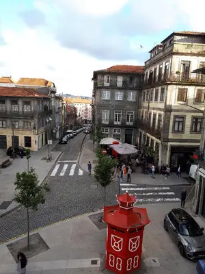 a red fire hydrant on a city street with buildings at Central Luxury apartment w AC Downtown and Metro in Porto