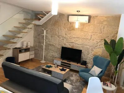 a living room with a couch and a tv and stairs at URBAN VIEWS Terrace - Duplex Apartment 