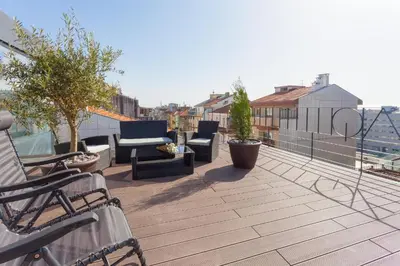 a balcony with chairs and furniture on a roof at URBAN VIEWS Terrace - Duplex Apartment 