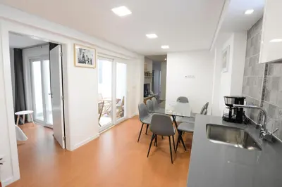a kitchen and dining room with a table and chairs at LUXURY Golden River Apartment - In the Heart of city center and wine cellars in Vila Nova de Gaia