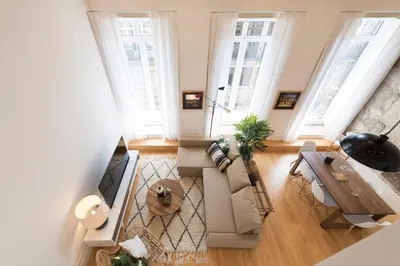 a living room with a couch and a table at BmyGuest Collection - Downtown Mezzanine Apartment in Porto