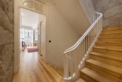 a staircase in a home with wooden floors at LovelyStay - Rico's Apartment - Almada 2º F in Porto