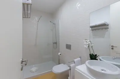 a bathroom with a sink and a toilet and a shower at Porto Blue Terrace in Porto