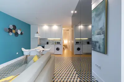 a living room with a white couch and a kitchen at Porto Blue Terrace in Porto