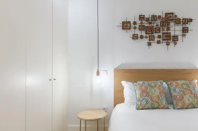 a bedroom with a bed with a wooden headboard and a table at Porto Blue Terrace in Porto