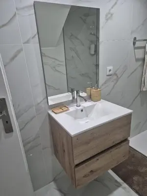 a bathroom with a blue tiled wall at Downtown Porto Bonfim Studio Apt in Porto