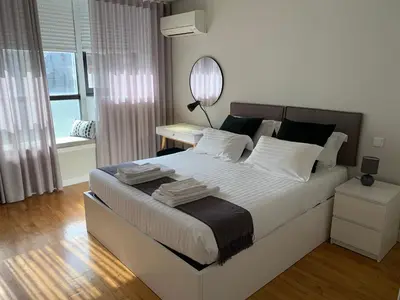 a bedroom with a large bed with a mirror on it at Porto Soul by Flat in Porto in Porto