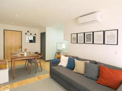 a living room with a couch and a table at FLH Porto Modern Apartment in Porto