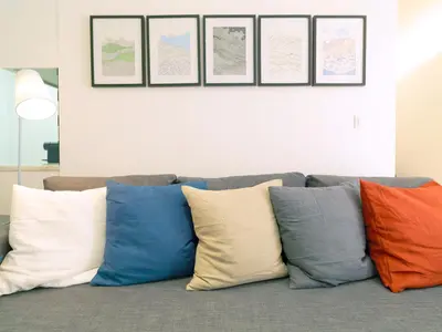 a row of colorful pillows sitting on a couch at FLH Porto Modern Apartment in Porto