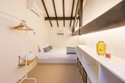 a small room with a bed and a desk at Republica Apartments at D. Luis I Bridge in Vila Nova de Gaia