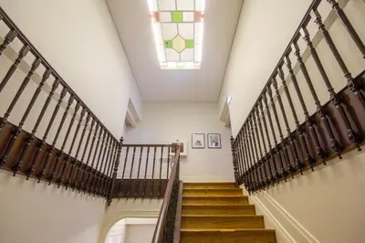 a staircase in a building with a stained glass window at Republica Apartments at D. Luis I Bridge in Vila Nova de Gaia