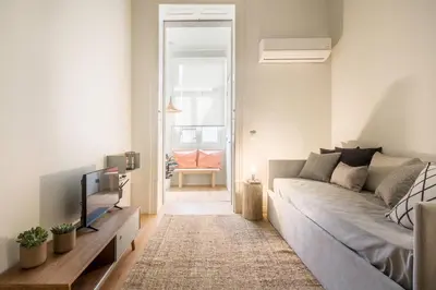 a living room with a couch and a tv at Republica Apartments at D. Luis I Bridge in Vila Nova de Gaia