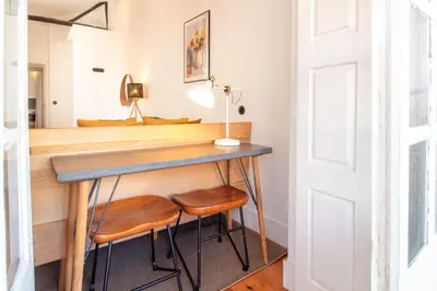 a home office with a desk and two stools at LovelyStay - Dirk Apartment Almada 3º T in Porto