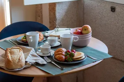 a table with breakfast foods and a bowl of fruit at LovelyStay - Dirk Apartment - Almada 4º F in Porto