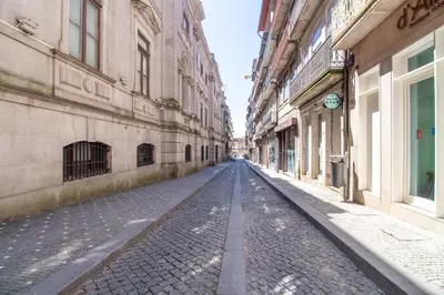 an empty street in an alley between two buildings at LovelyStay - Dirk Apartment - Almada 4º F in Porto